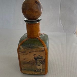 Vintage Italian leather decanter with golf scene. Original wood stopper.